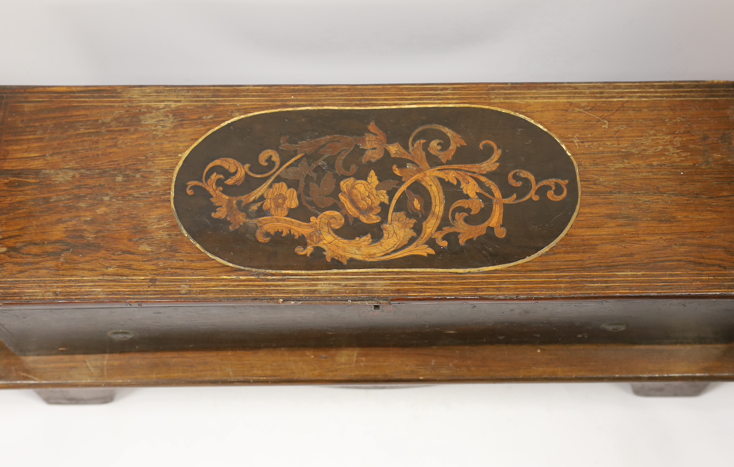 A late 19th century Swiss ‘forte piano’ cylinder musical box, in an inlaid mahogany case, playing four airs on two hundred and nineteen teeth, barrel 39cm wide, case; 57cm wide, 17cm deep, 13cm high, on a later separate